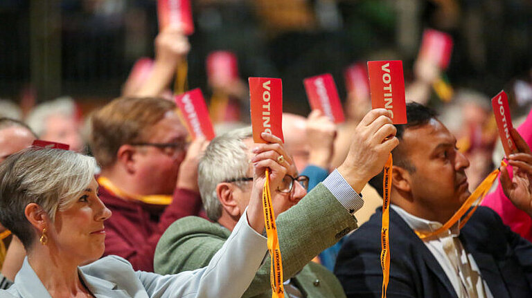 Conference Attendees Voting on a Policy Motion