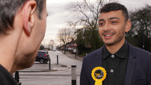 Young Councillor Anton talking to a voter