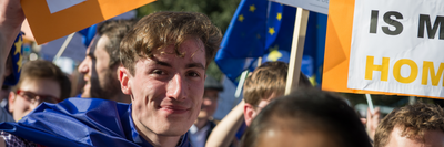 YL members campaigning in front of an EU flag